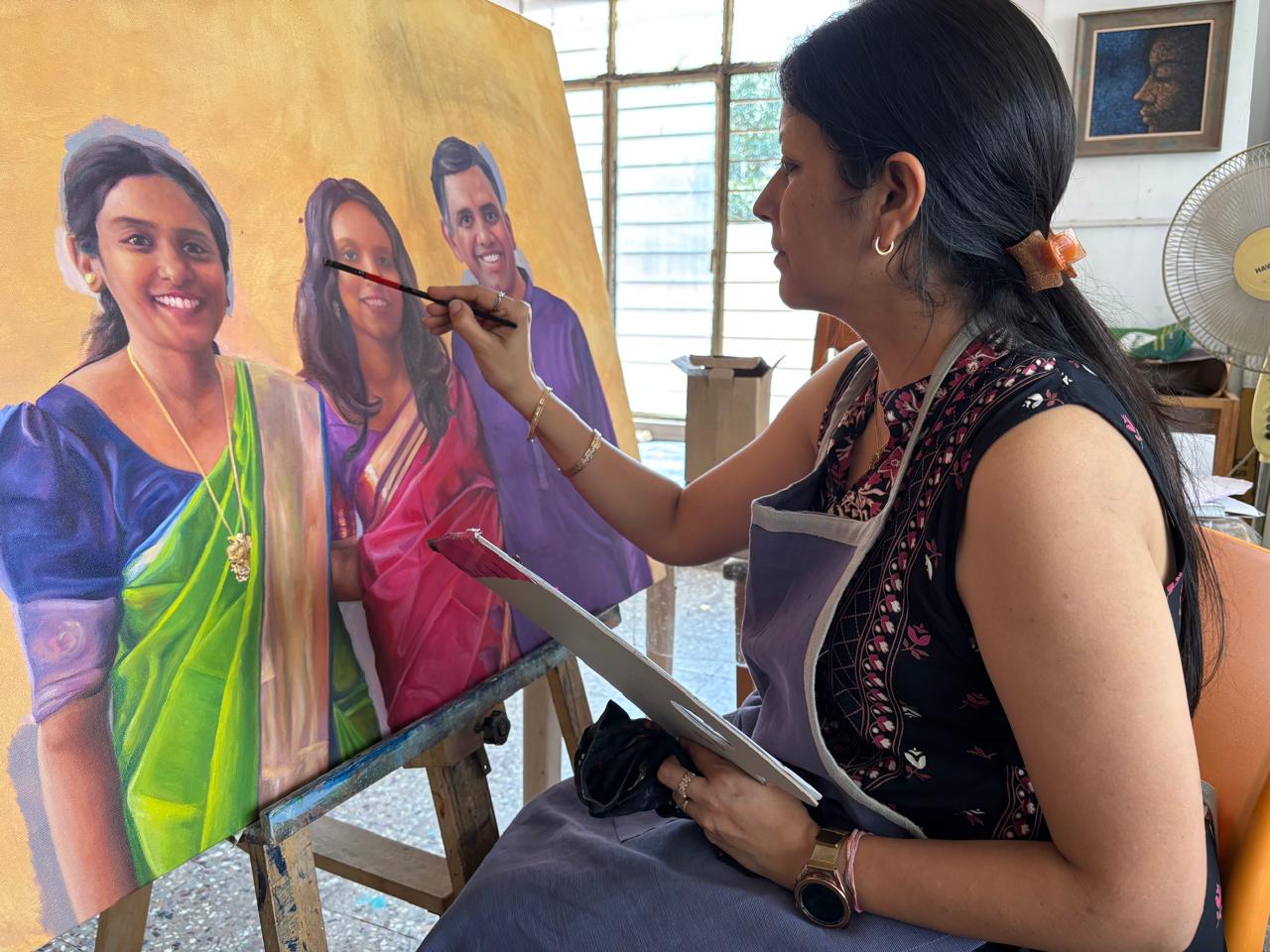 Nidhi at work on the family portrait